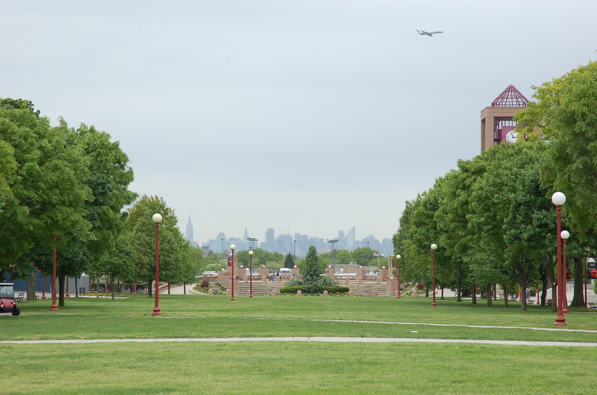 The Queens College Quad, with the Manhattan skyline in the distance and the library clock tower on the right